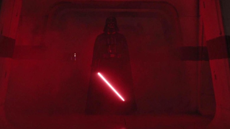 Darth Vader stands in a hallway with his lightsaber in Rogue One: A Star Wars Story (2016)