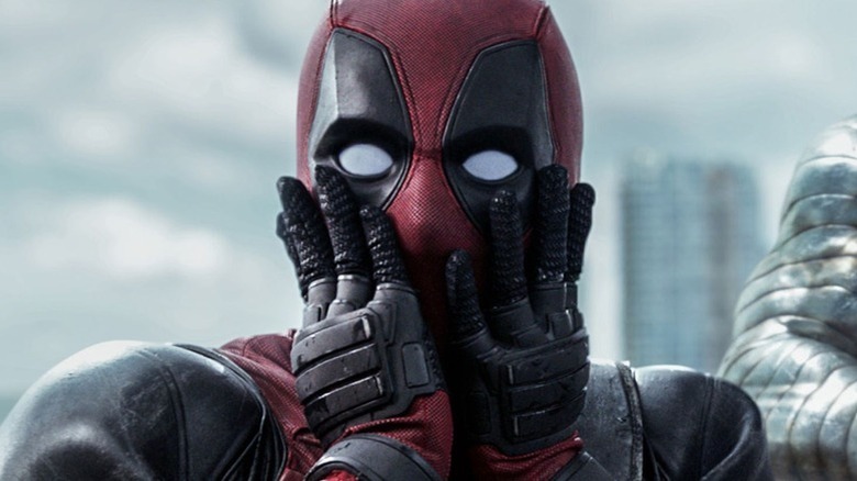 Deadpool holding his face