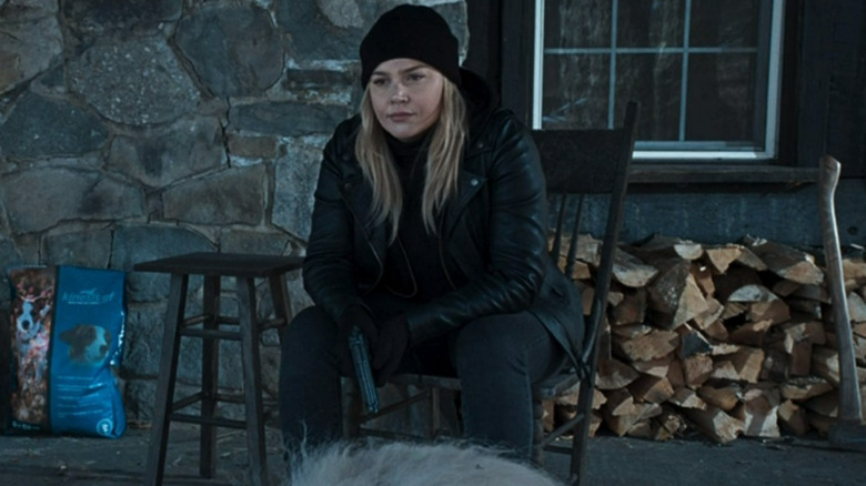 The Waitress sitting and holding gun