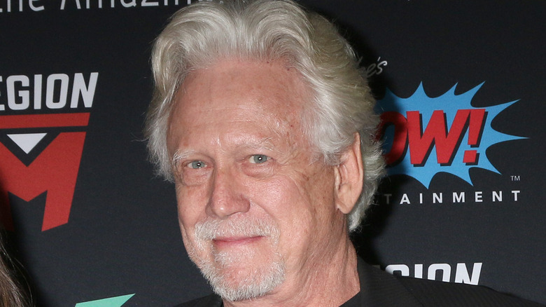 Bruce Davison walks on a red carpet