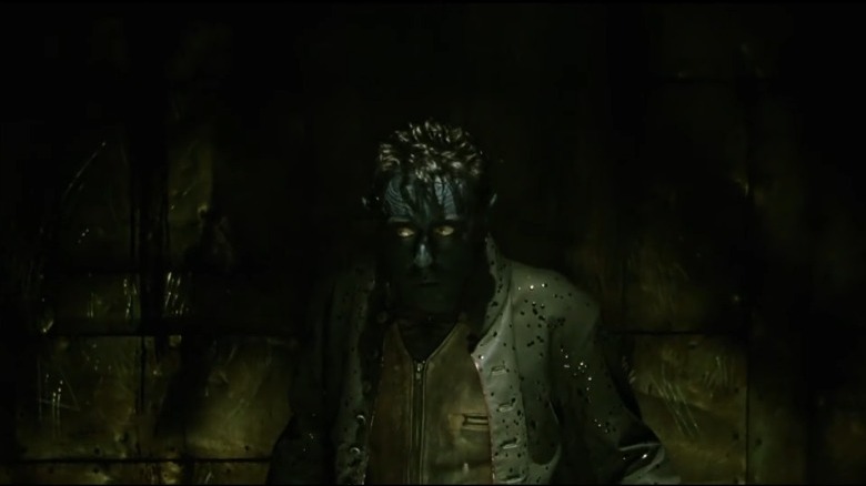 Nightcrawler standing in a dark corner