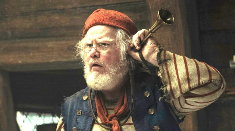 Mr. Smee holding ear trumpet