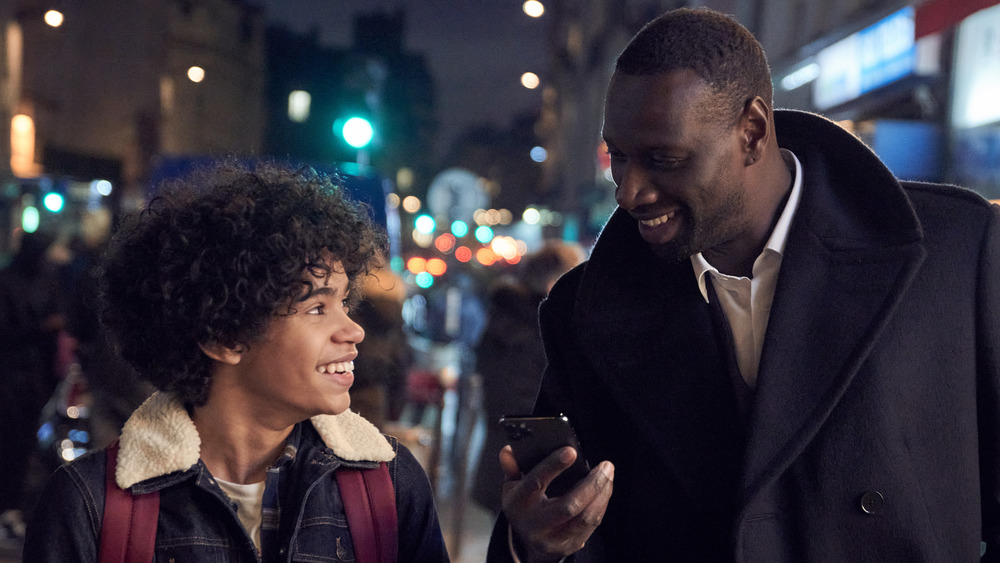 Assane Diop laughing with kid