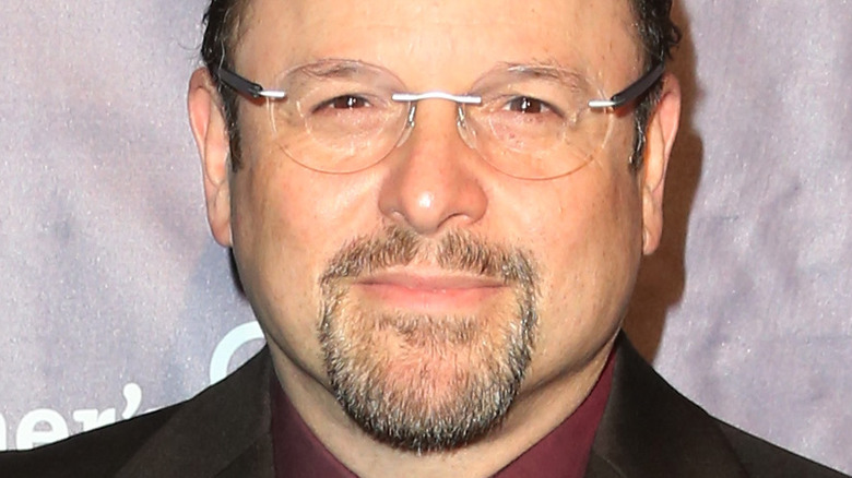 Jason Alexander smiling at an event 