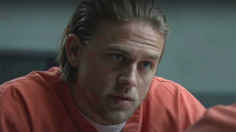 Jax wearing prison jumpsuit