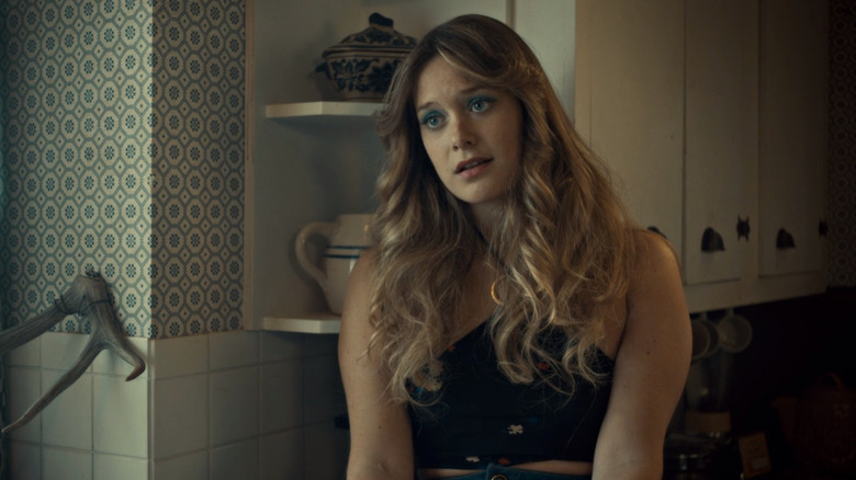 Simone sitting in a kitchen