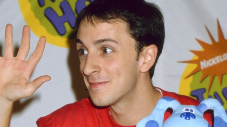 Young Steve Burns waving and holding Blue