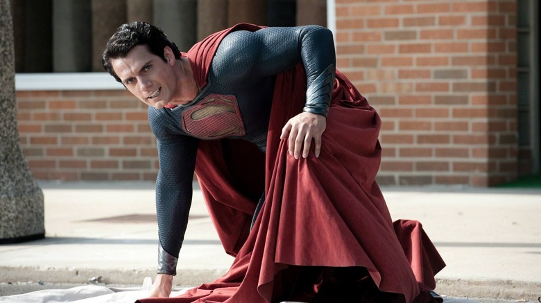 Superman kneeling on the street