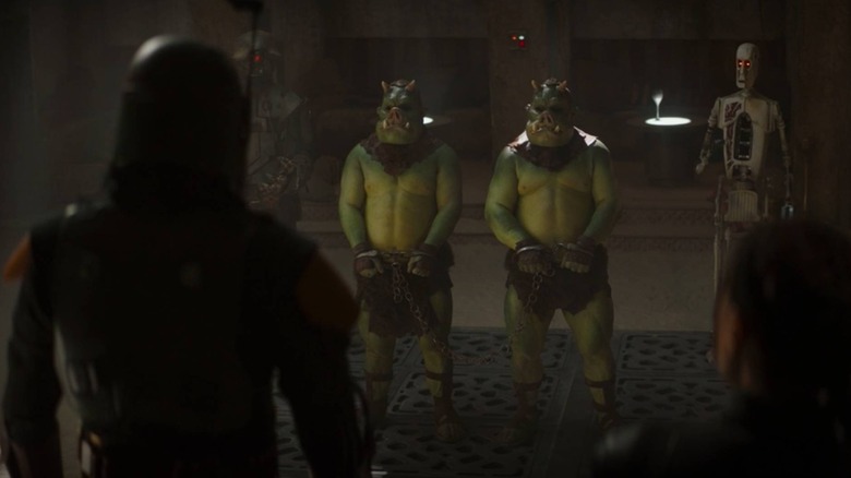 Gamorrean guards standing before Boba Fett