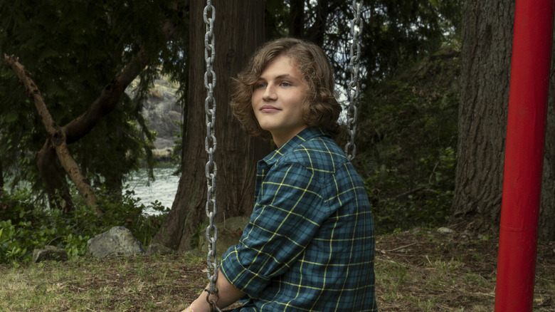 Young Sam sitting in a swing on Every Year After