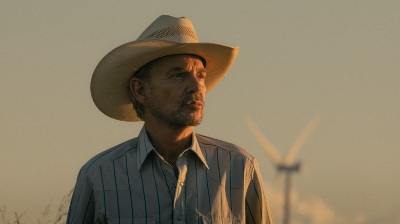 Billy Bob Thornton as Tommy Norris in Landman in front of a windmill