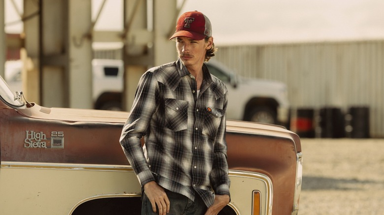 Jacob Lofland as Cooper on Landman in font of a pickup truck