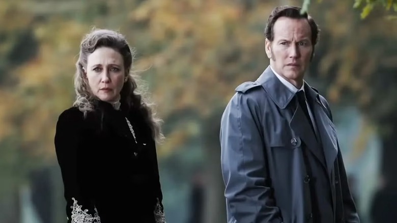 The Warrens looking dubious in a cemetary in "The Conjuring: Last Rites" (2025)