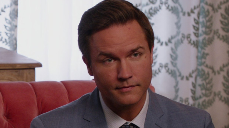 Paul Randolph sits on a couch and stares forward in "Ginny & Georgia" (2021-2025)