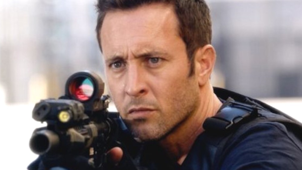 Steve McGarrett holding a gun