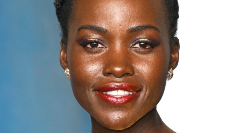 Lupita Nyong'o smiling at oscars 2022