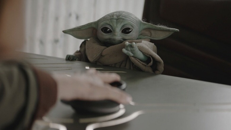 Grogu reaches for a button in "Star Wars: The Mandalorian And Grogu" (2026)