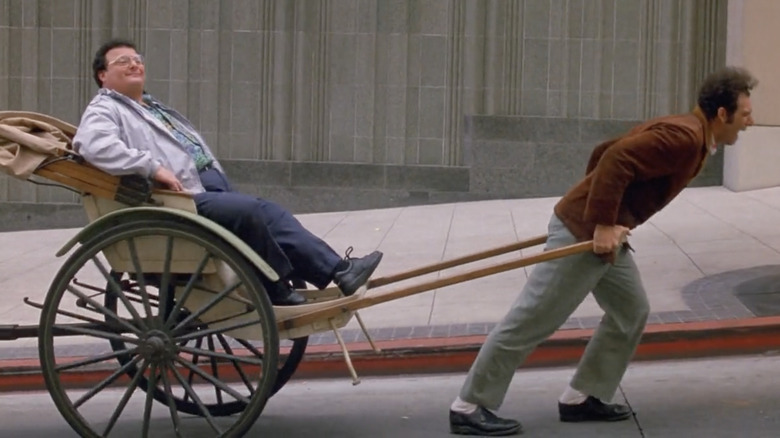 Cosmo Kramer pulling Newman in a rickshaw