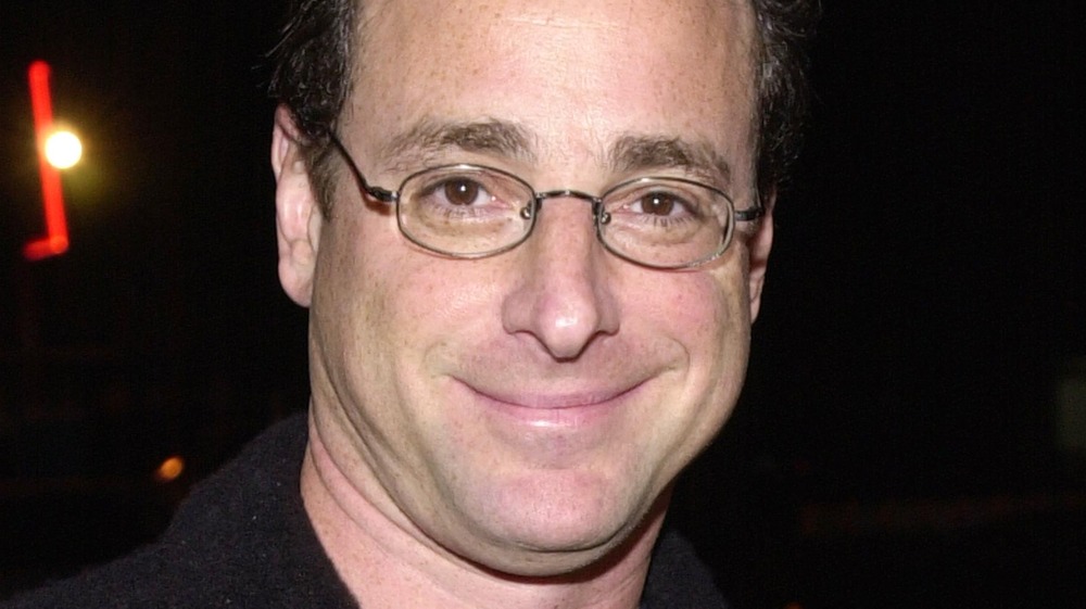 Bob Saget poses at an event