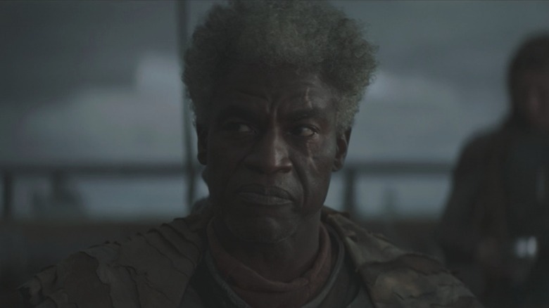Mandalorian Survivor Captain frowning aboard his sandcrawler