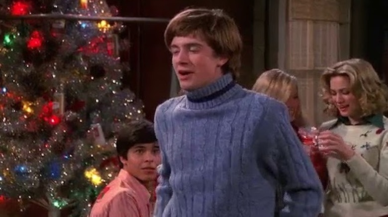 Eric Forman squinting near Christmas tree