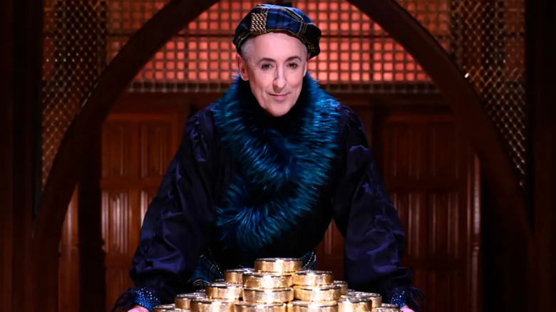 Alan Cumming with a pile of gold coins in"The Traitors" (2023-present)