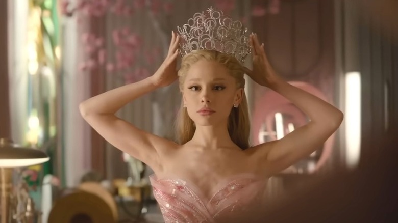 Glinda putting a crown on her head