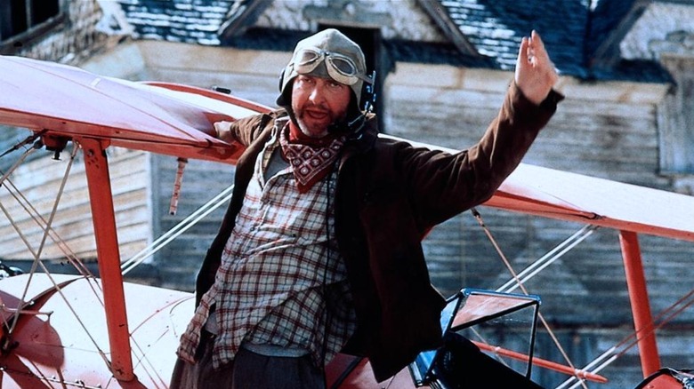 Russell Casse hanging off of his plane in Independence Day