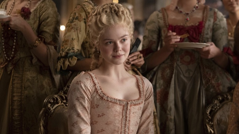 Catherine sitting amongst her ladies smirking in The Great