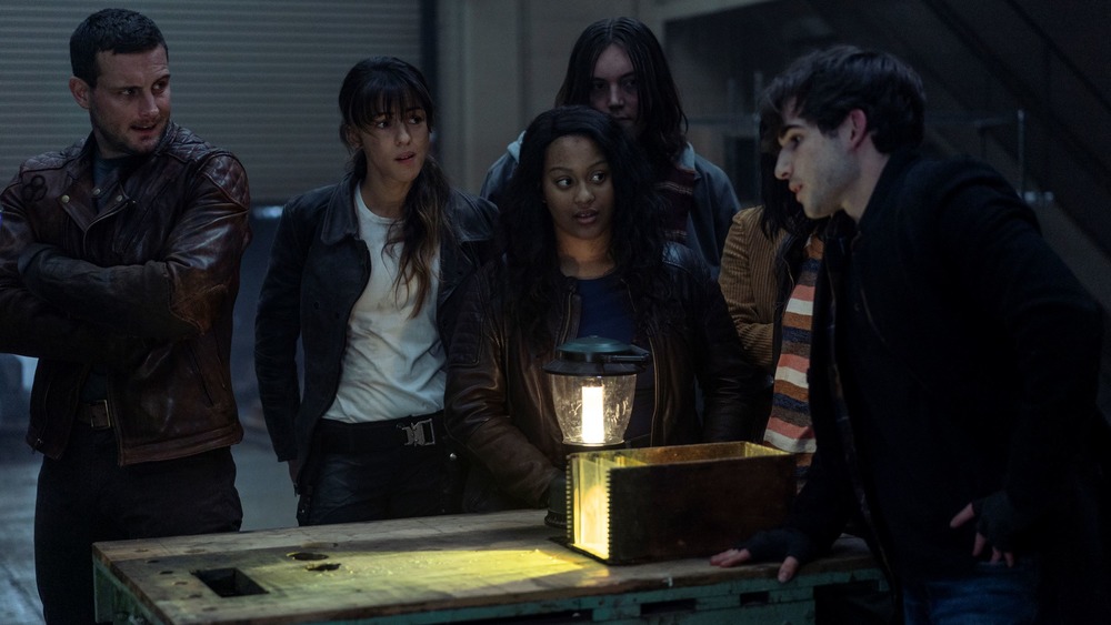 Huck (Annet Mahendru) and Felix (Nico Tortorella) watch Silas perform a trick on The Walking Dead: World Beyond