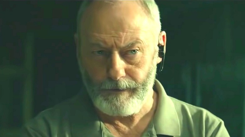 Liam Cunningham with eyebrow raised in 'The Vault'