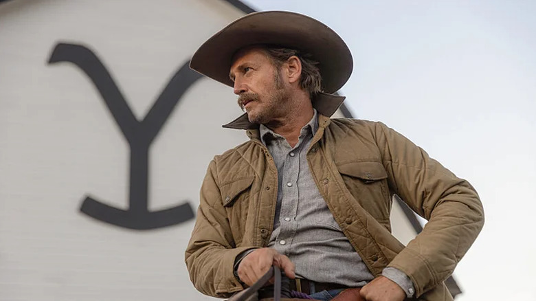 Young John Dutton on horseback in front of the barn on Yellowstone (2018-2024)