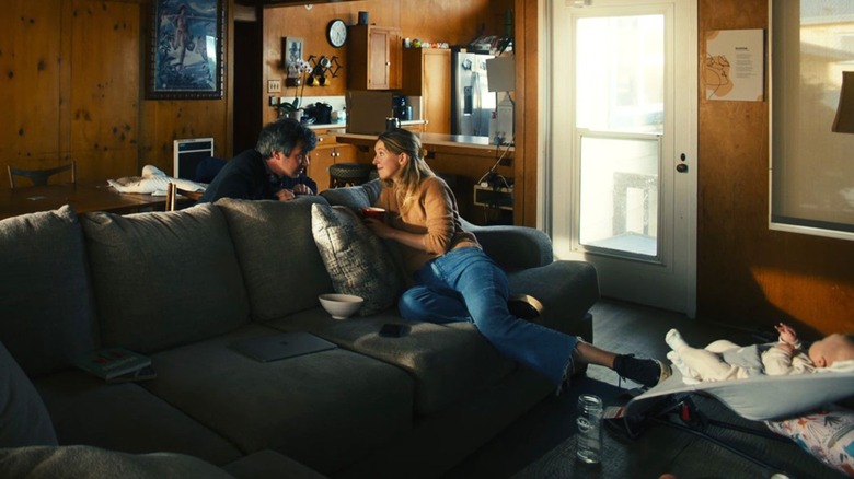 Nathan and Elizabeth talking near the baby in her beach house rental in You Can See Everything