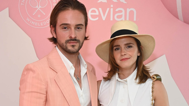 Alex Watson and Emma Watson posing in the evian VIP Suite at Wimbledon 2023