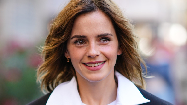 Emma Watson smiling in a suit