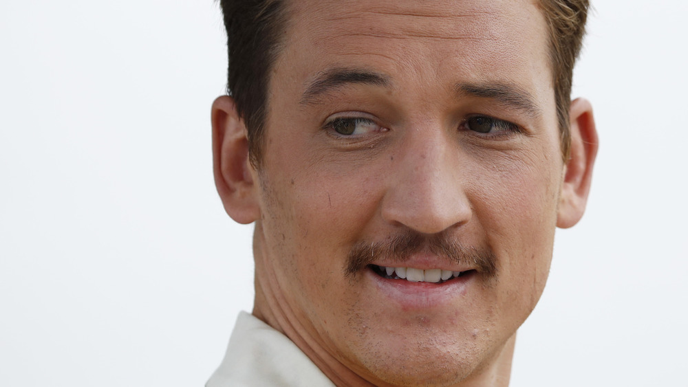 Miles Teller smirking