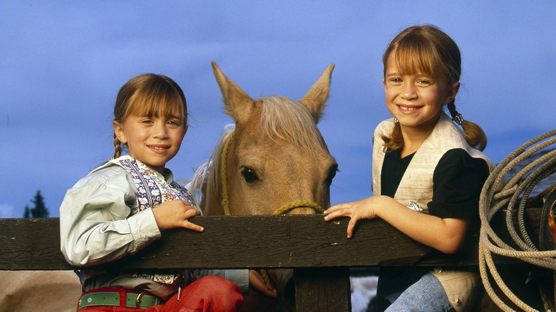 Mary-Kate and Ashley Olsen pose with horses for Disney TV movie How the West Was Fun