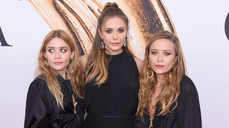 Mary-Kate, Ashley, and Elizabeth Olsen at an event