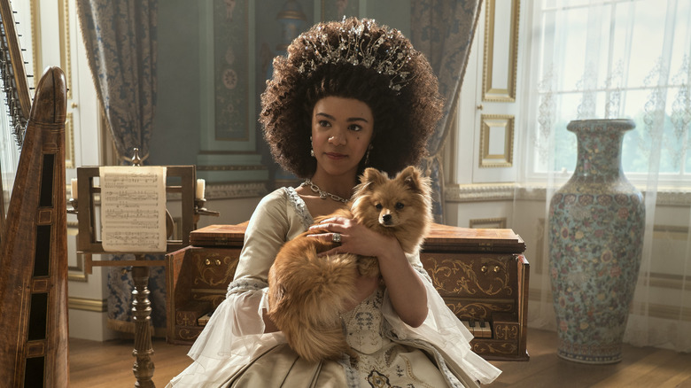 Queen Charlotte holds a dog