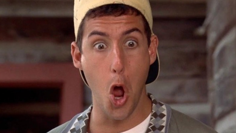 Billy Madison wearing a backwards cap looking shocked