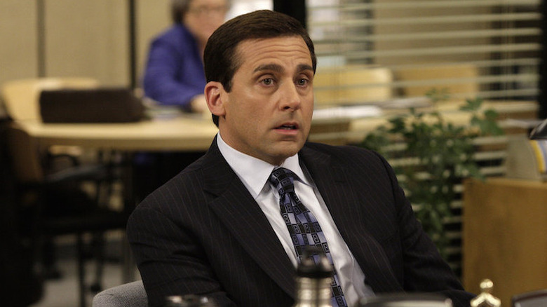Michael talking at desk worried