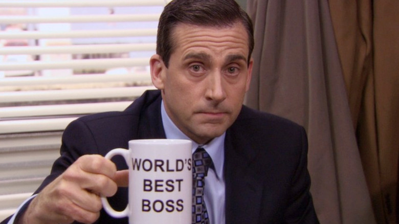 Michael holding World's Best Boss mug