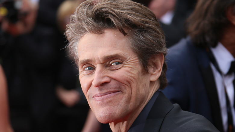 Willem Dafoe smirking