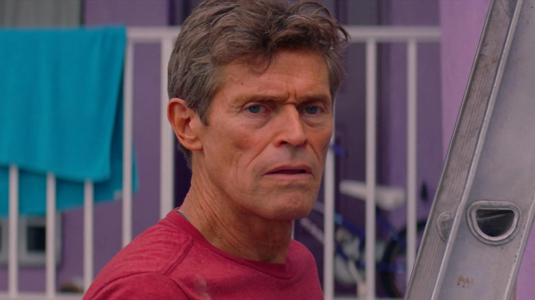 Willem Dafoe looks onward