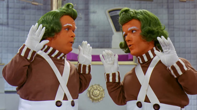 Oompa Loompas looking at each other and singing 