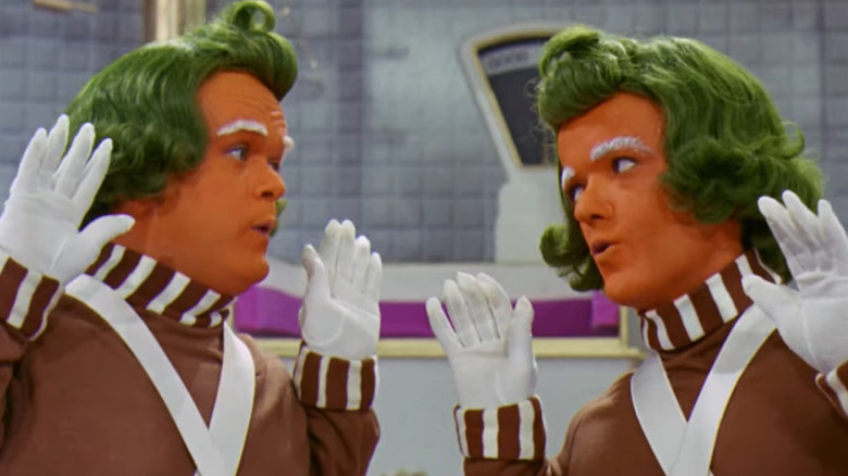 Oompa Loompas looking at each other and singing