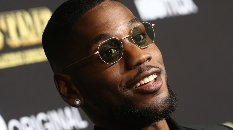 Quincy Isaiah wearing sunglasses and earring