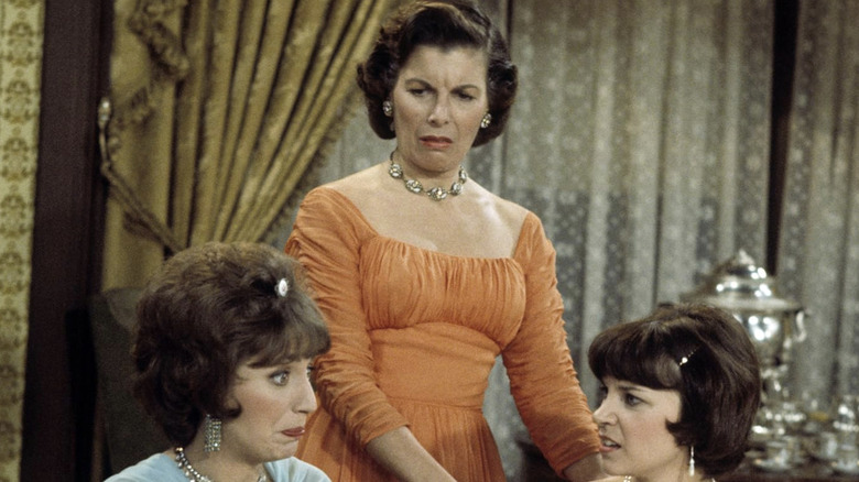 Kathryn Ish stands behind Laverne and Shirley, scowling