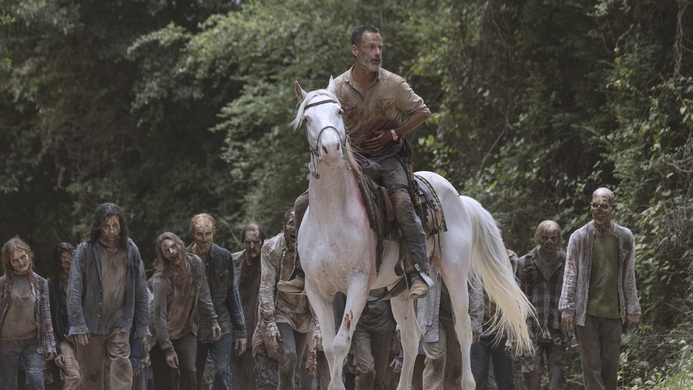 Rick Grimes leading a pack of walkers on horseback on The Walking Dead