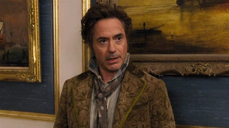 Doctor Dolittle standing in front of painting in Dolittle (2020)